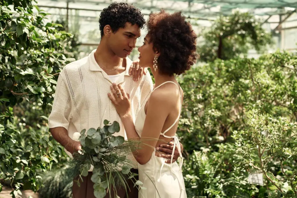 Couple embracing in lush green garden.