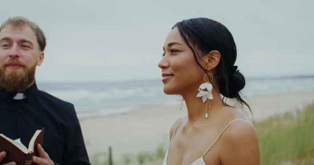 Bride and officiant at a beach wedding.