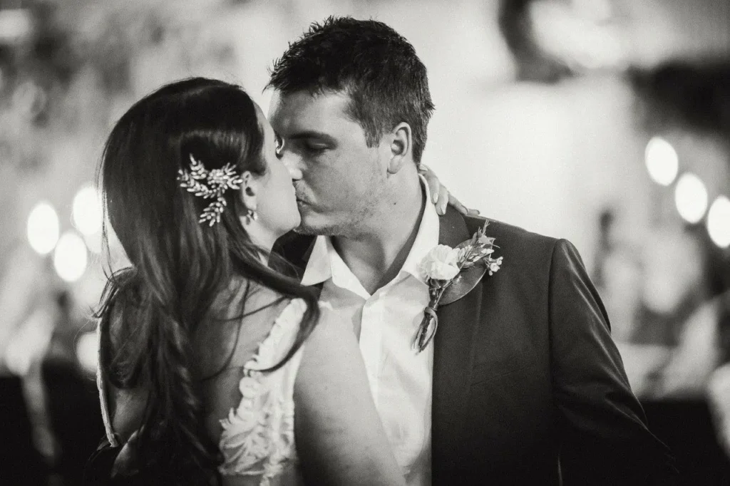 Bride and groom sharing a romantic kiss.