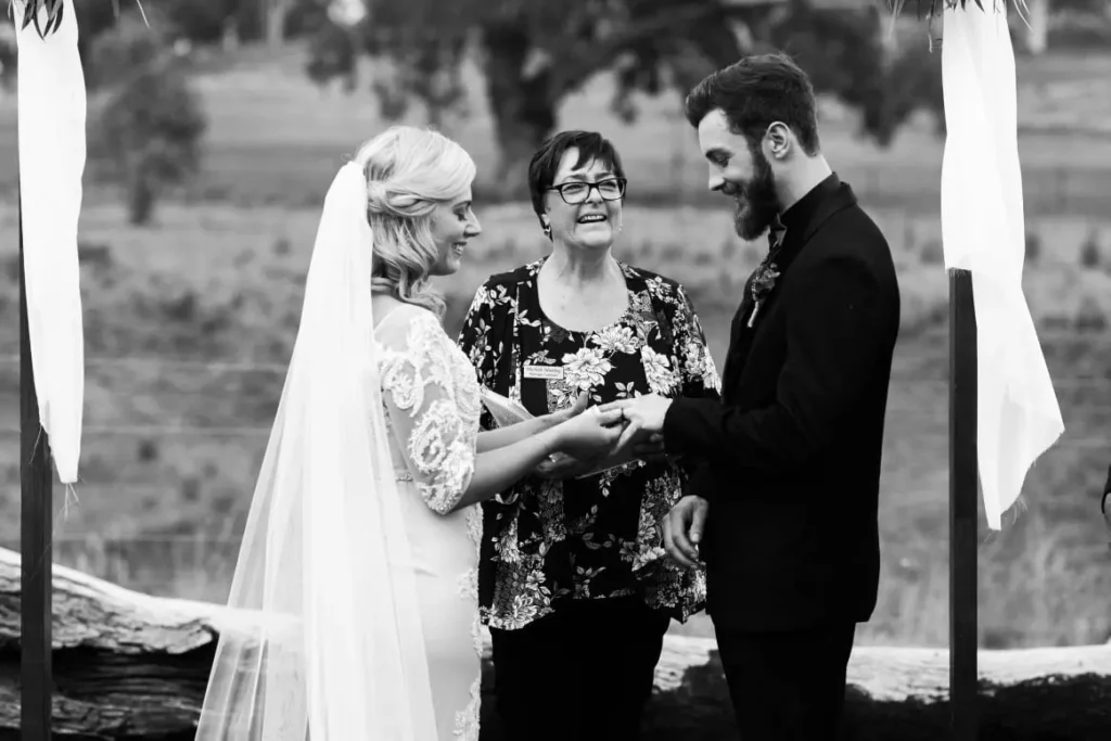 Bride and groom exchanging rings at wedding.